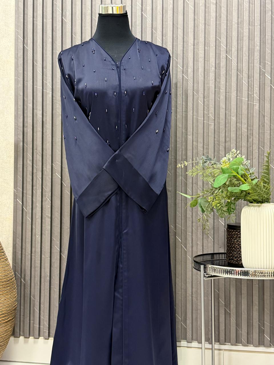 Buttoned up, tubes beaded work on the upper body