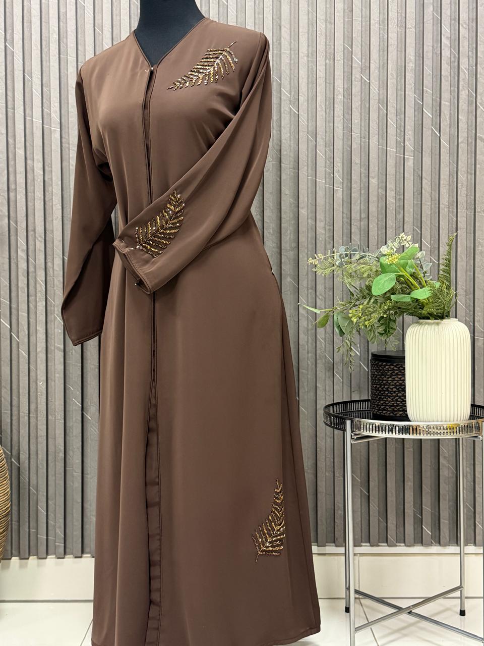 Buttoned up, beaded work on the shoulder and sleeves