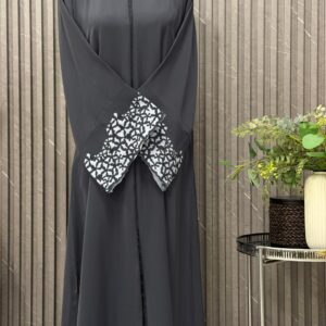 Buttoned up, laser work on the sleeves with embedded stones