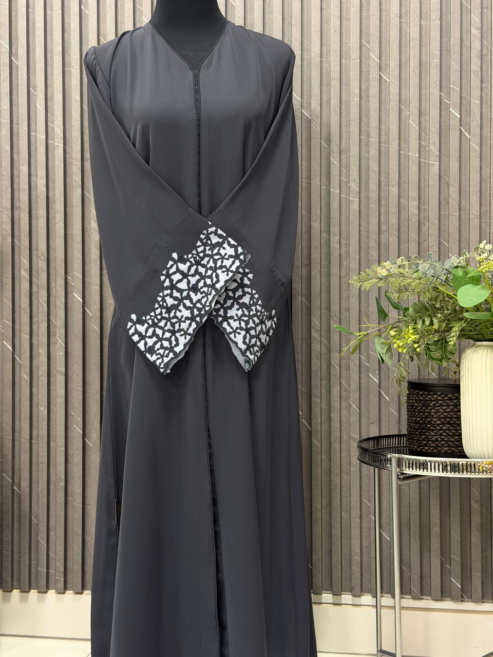 Buttoned up, laser work on the sleeves with embedded stones