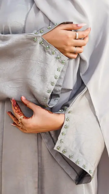 Buttoned up straight abaya with embedded beads on the sleeve
