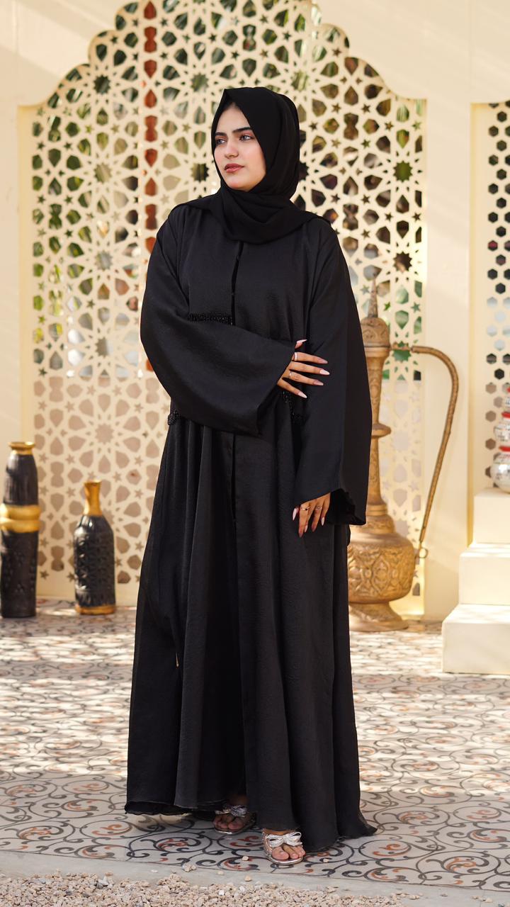 A timeless abaya made from premium organza fabric, featuring elegant all-over detailing. Its graceful flow and refined finish make it ideal for formal and festive wear.