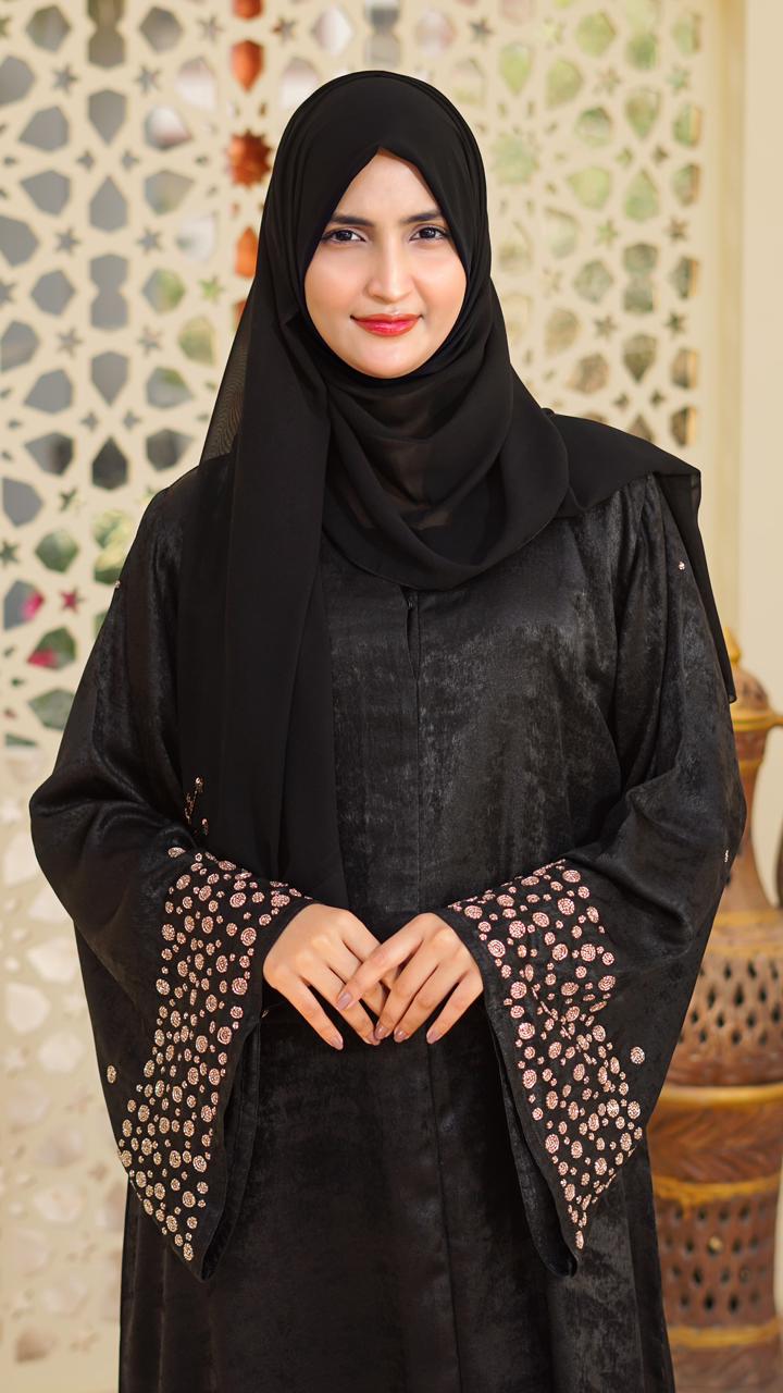 A refined abaya in premium Roso fabric, highlighted with elegant rose-gold work on the sleeves and duppata for a subtle, luxurious finish.