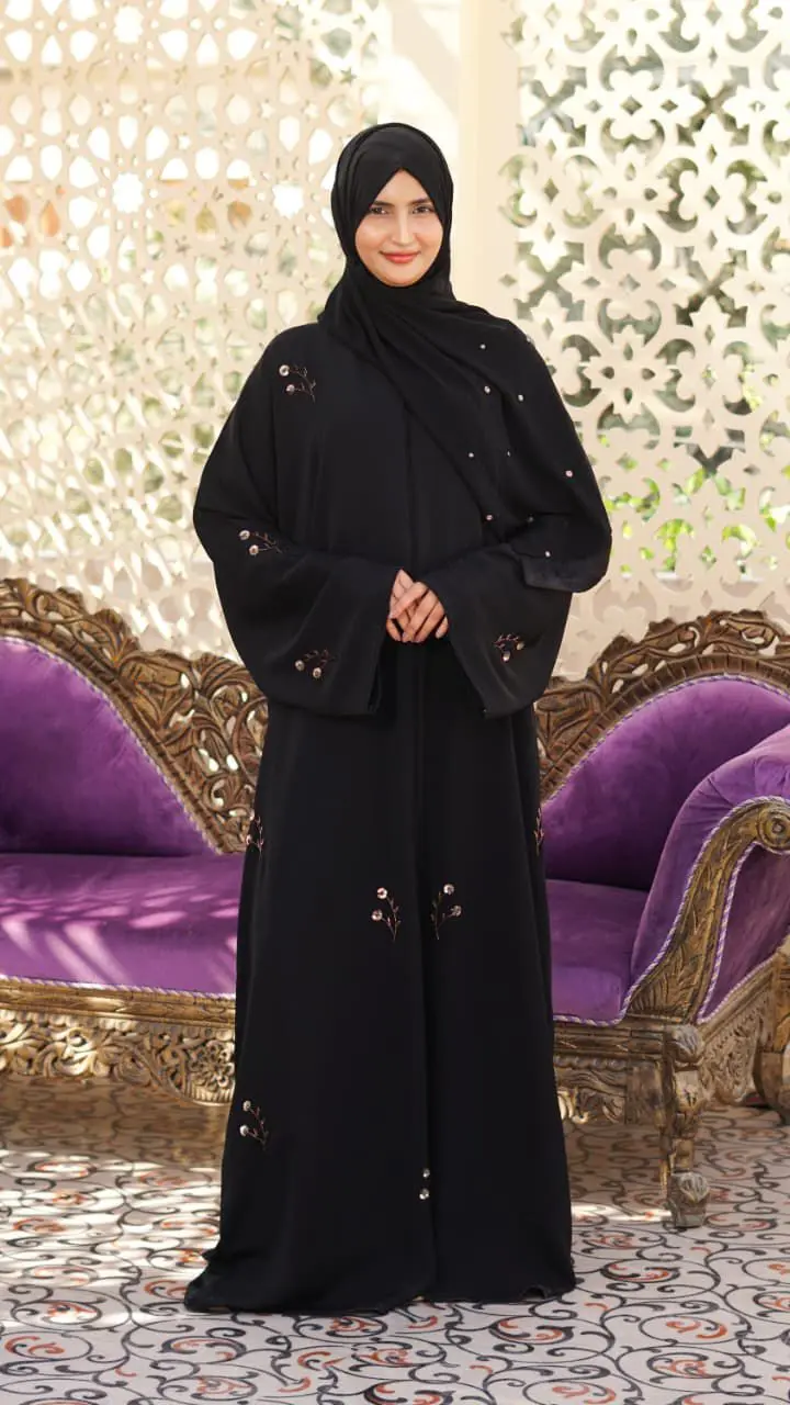 Black Nada fabric abaya with a soft, flowing drape, featuring delicate floral embroidery and subtle bead details - Image 3