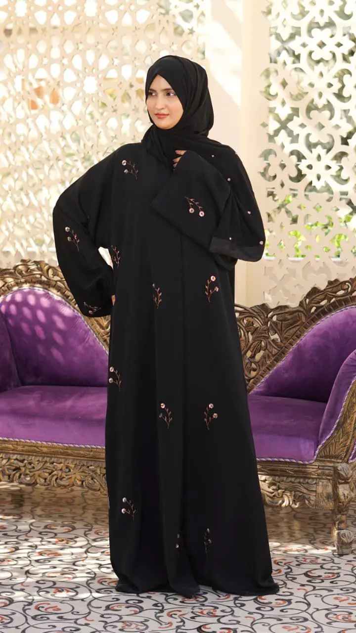Black Nada fabric abaya with a soft, flowing drape, featuring delicate floral embroidery and subtle bead details - Image 4