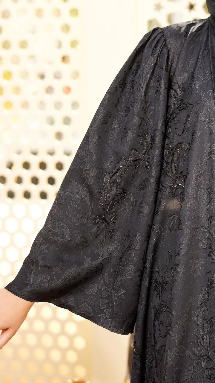 Straight-cut abaya crafted in self-designed fabric, enhanced with fine cut bead embellishment